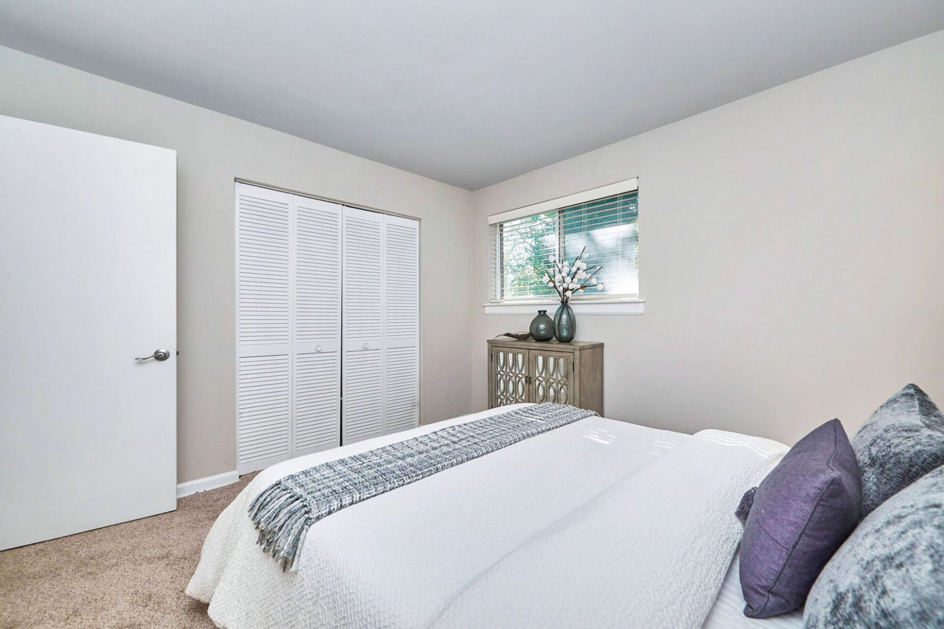 Asbury Place - Purple Bedroom Closet Closed Luxury Two-Bedroom Apartments with White Bed